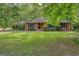 Traditional brick home featuring a well-manicured lawn and mature shade trees at 205 Olde Oak Dr, Jonesboro, GA 30238