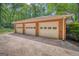 Spacious three-car garage with brick exterior and ample parking space at 205 Olde Oak Dr, Jonesboro, GA 30238