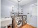 Functional laundry room includes modern washer and dryer, utility sink, and convenient storage at 205 Olde Oak Dr, Jonesboro, GA 30238