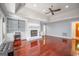 Bright living room featuring hardwood floors, fireplace, built-in shelves, and natural light at 205 Olde Oak Dr, Jonesboro, GA 30238