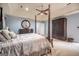 This main bedroom has a tray ceiling, carpet floors, and a canopy bed at 205 Olde Oak Dr, Jonesboro, GA 30238