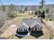 An aerial view showcases the house and its surroundings and a lush lawn to enjoy outdoor activities at 321 Harris Ave, Locust Grove, GA 30248