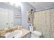 Bathroom featuring a toilet, shower and tub combination, and a single sink vanity at 321 Harris Ave, Locust Grove, GA 30248