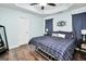 This primary bedroom features a trey ceiling, wood flooring, and a large bed at 321 Harris Ave, Locust Grove, GA 30248