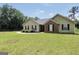 Charming single-story home with green lawn, brick facade, black shutters and manicured landscaping at 321 Harris Ave, Locust Grove, GA 30248