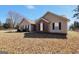 A close exterior shot of the home showing the brick and siding detail at 321 Harris Ave, Locust Grove, GA 30248
