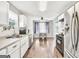 Well-lit kitchen with stainless steel appliances offers view to a dining area, blending cooking with Gathering life at 321 Harris Ave, Locust Grove, GA 30248