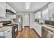 Functional kitchen with stainless steel appliances, wood-look flooring, and ample counter space at 321 Harris Ave, Locust Grove, GA 30248