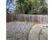 Fenced backyard features gravel landscaping with a concrete path, offering a private outdoor space at 7560 Taylor Rd # 1, Riverdale, GA 30274