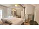 Bedroom with silver furniture, including dresser, mirror, and a four-poster bed with white bedding at 1622 Brentwood Se Xing, Conyers, GA 30013