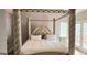 Bedroom features bed with luxurious headboard, decorative posts, and bright window at 1622 Brentwood Se Xing, Conyers, GA 30013