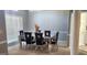 Dining room with modern mirrored table, six black chairs, chandelier and bright windows at 1622 Brentwood Se Xing, Conyers, GA 30013