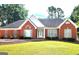 Charming single-story brick home with well-manicured lawn and mature landscaping at 1622 Brentwood Se Xing, Conyers, GA 30013