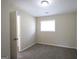 Bedroom with neutral walls and flooring; window offers natural light at 3578 Sherbrooke Sw Way, Atlanta, GA 30331