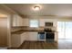 Updated kitchen with white cabinets, modern appliances, and granite countertops at 3578 Sherbrooke Sw Way, Atlanta, GA 30331