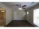 Bright living room featuring neutral walls, fan, and newly installed floors at 3578 Sherbrooke Sw Way, Atlanta, GA 30331