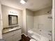 Well-maintained bathroom with a shower-tub combo, granite vanity, and updated fixtures at 3228 Rivermist Cv, Decatur, GA 30034