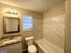 Bathroom featuring marble backsplash, granite countertops, and white ceramic toilet and bathtub at 3228 Rivermist Cv, Decatur, GA 30034