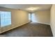 Spacious bedroom with carpet, two large windows, and neutral paint at 3228 Rivermist Cv, Decatur, GA 30034