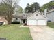 Charming one-story home featuring a two-car garage, well-maintained lawn, and traditional architectural details at 3228 Rivermist Cv, Decatur, GA 30034