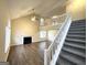 Inviting living room featuring high ceilings, a fireplace, laminate flooring and a staircase to the second level at 3228 Rivermist Cv, Decatur, GA 30034