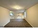 Open loft area featuring neutral carpeting and a white railing overlooking the lower level at 3228 Rivermist Cv, Decatur, GA 30034