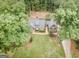 Aerial view of home, nestled among trees and featuring a well-maintained lawn and brick walkway at 107 Rolling Grn, Peachtree City, GA 30269