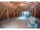 Unfinished attic space with exposed wood beams, offering potential for customization at 107 Rolling Grn, Peachtree City, GA 30269