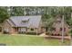 Charming single-Gathering home with brick accents, lush landscaping, and a well-manicured lawn surrounded by mature trees at 107 Rolling Grn, Peachtree City, GA 30269