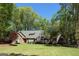 Charming single-Gathering home with brick accents, lush landscaping, and a well-manicured lawn surrounded by mature trees at 107 Rolling Grn, Peachtree City, GA 30269