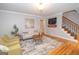 Comfortable living room featuring hardwood floors, modern decor, and a staircase at 107 Rolling Grn, Peachtree City, GA 30269