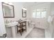 Modern bathroom with double sinks, decorative mirrors, and tile flooring at 107 Rolling Grn, Peachtree City, GA 30269