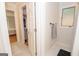 Well-lit bathroom showcasing marble flooring, a convenient towel rack, and a glimpse into an adjoining bedroom, adding luxury at 107 Rolling Grn, Peachtree City, GA 30269