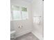 Bright bathroom featuring a tile floor, toilet, and leafy window privacy film at 107 Rolling Grn, Peachtree City, GA 30269