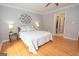 Comfortable bedroom with hardwood floors, stylish decor, and access to a walk-in closet, creating a cozy retreat at 107 Rolling Grn, Peachtree City, GA 30269