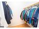 Organized walk-in closet with ample hanging space and clothing racks, perfect for wardrobe storage and easy access at 107 Rolling Grn, Peachtree City, GA 30269
