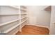 Spacious walk-in closet with custom shelving for organized storage at 107 Rolling Grn, Peachtree City, GA 30269