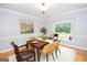 Comfortable dining room with hardwood floors, white trim, and view of the wooded backyard at 107 Rolling Grn, Peachtree City, GA 30269