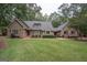 Charming brick home features a well-manicured lawn and mature landscaping at 107 Rolling Grn, Peachtree City, GA 30269