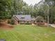 Beautiful single Gathering home with lush front lawn and mature trees at 107 Rolling Grn, Peachtree City, GA 30269