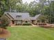 Beautiful single Gathering home with lush front lawn and mature trees at 107 Rolling Grn, Peachtree City, GA 30269