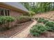 Exquisite landscaping with a gravel path and beautiful greenery surrounds this home at 107 Rolling Grn, Peachtree City, GA 30269