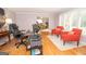 Living room includes hardwood floors, white shutters, and a work space including desk, office chair, and printer at 107 Rolling Grn, Peachtree City, GA 30269