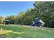 Community playground featuring a slide, swings and picnic area near lush green trees at 107 Rolling Grn, Peachtree City, GA 30269