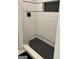 Contemporary shower featuring black and white tiling and a built-in niche for toiletries, combining style with functionality at 107 Rolling Grn, Peachtree City, GA 30269