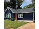 Charming single-story home with a well-manicured lawn, navy siding, and red front door at 609 Spring St, Atlanta, GA 30354