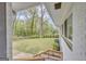 View of the expansive backyard featuring a green lawn, mature trees, and manicured landscaping at 2694 Benjamin E Mays Sw Dr, Atlanta, GA 30311