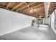 Spacious basement featuring white walls, exposed wooden beams, and concrete floor, ideal for storage at 2694 Benjamin E Mays Sw Dr, Atlanta, GA 30311