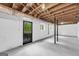 Partially finished basement with a door to the outside, white walls, plumbing, and exposed ceiling at 2694 Benjamin E Mays Sw Dr, Atlanta, GA 30311