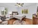 Cozy bedroom with hardwood floors, neutral decor, ceiling fan, and lots of natural light at 2694 Benjamin E Mays Sw Dr, Atlanta, GA 30311